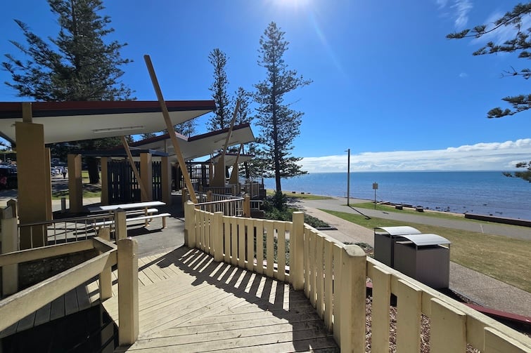 Wooden boardwalk and view of water at Rotary Park (Amity Playground) in Redcliffe.