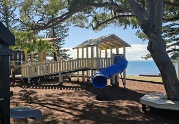 Blue tunnel slide at Rotary Park (Amity Playground) in Redcliffe.