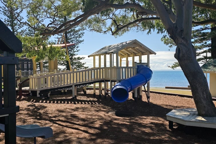 Blue tunnel slide at Rotary Park (Amity Playground) in Redcliffe.