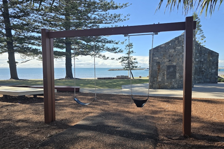Swings with a view to the water at Rotary Park (Amity Playground) in Redcliffe.