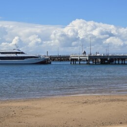 View of water, Redcliffe Jetty and Eye Spy boat at Rotary Park (Amity Playground) in Redcliffe.