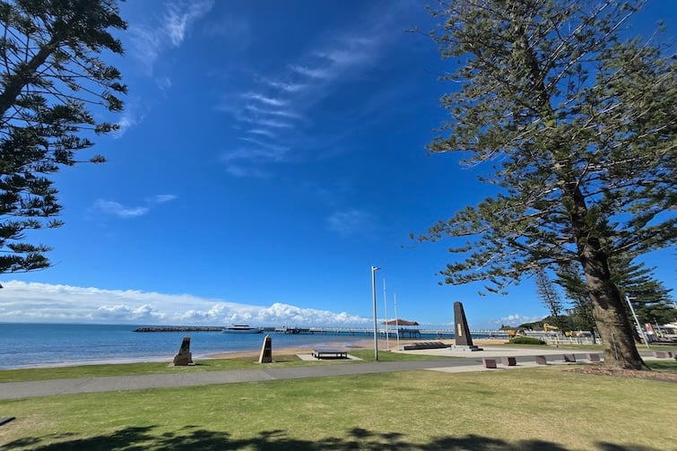 View of blue skies and Redcliffe Jetty at Rotary Park (Amity Playground) in Redcliffe.