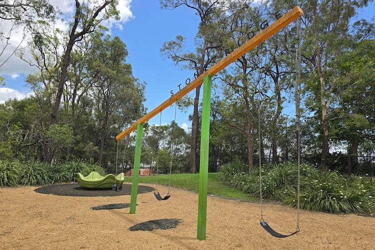 Swings and merry-go-round at Stone Ridge Central Park in Narangba.