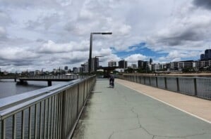 Person riding a bike along the Brisbane Riverwalk.