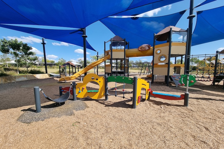 Play equipment under shade sails at Bumble Bee Park in Ripley.
