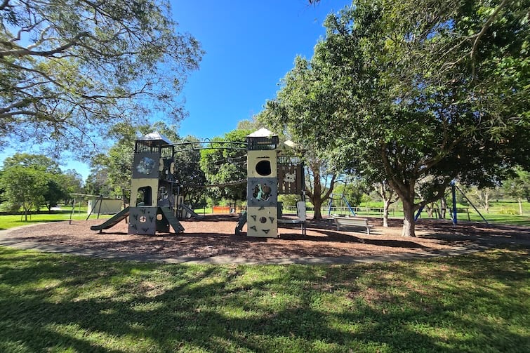 Green grass surround the playground at Harold Kielly Park.