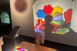 Girl in front of projectors at LightPlay, Ipswich Art Gallery.