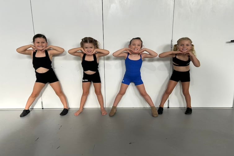 Four children striking a pose against a wall at Studio One Performance Hub.