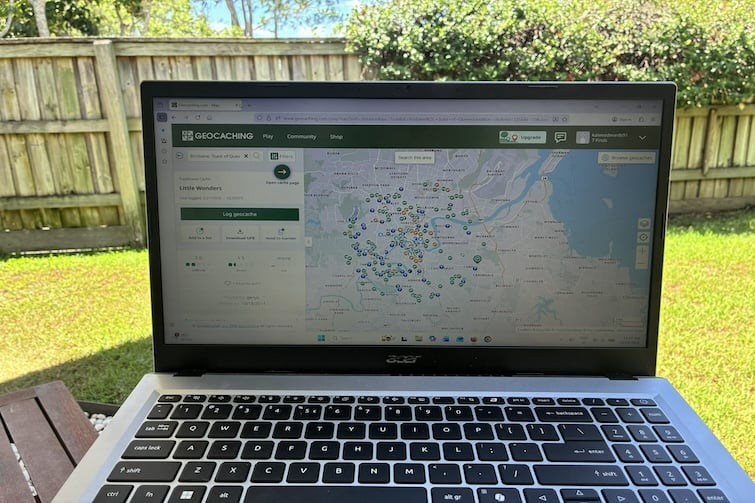 A laptop showing a map of geocache locations.