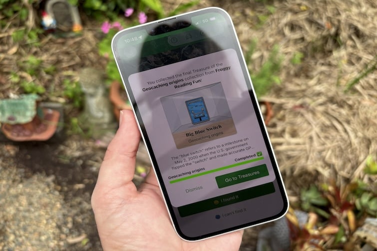 Phone showing geocaching app.