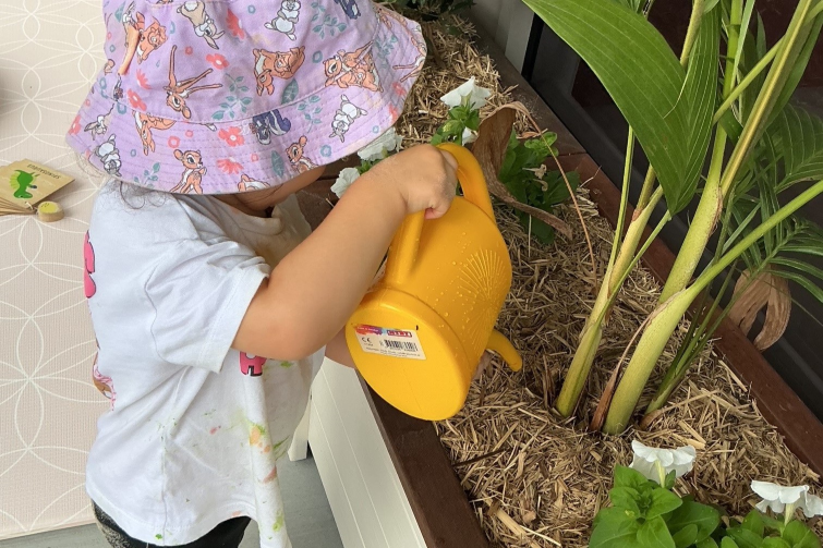 Corymbia Early Learning child watering plants.
