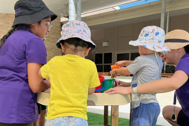 Corymbia Early Learning staff outdoors with children.