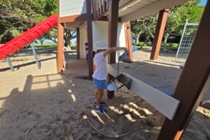 Girl playing in the sand play area at Happy Valley Playground in Caloundra.