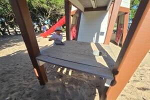 Girl playing in the sand play area at Happy Valley Playground in Caloundra.