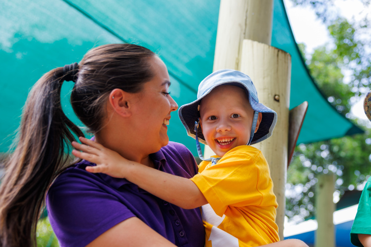 Lady Gowrie smiling child with carer.