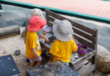 Lady Gowrie playing at outdoor mud kitchen.