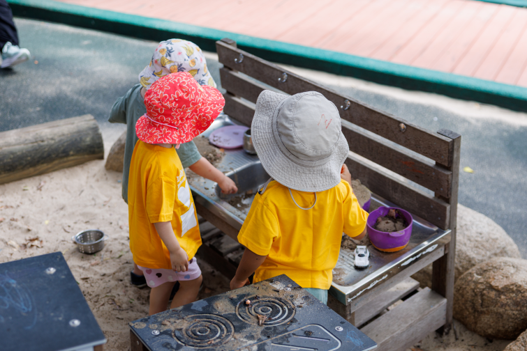 Lady Gowrie playing at outdoor mud kitchen.
