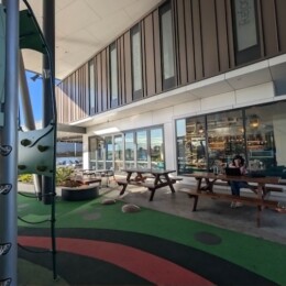 Outdoor seating next to playground at Degani Capestone.
