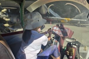 Child in gyrocopter pretending to fly it at Queensland Air Museum, Caloundra.