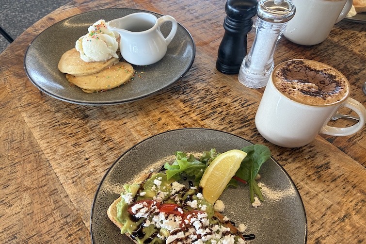 Plates of food and coffee on a table at Chapters Book Shop Cafe, Karalee.