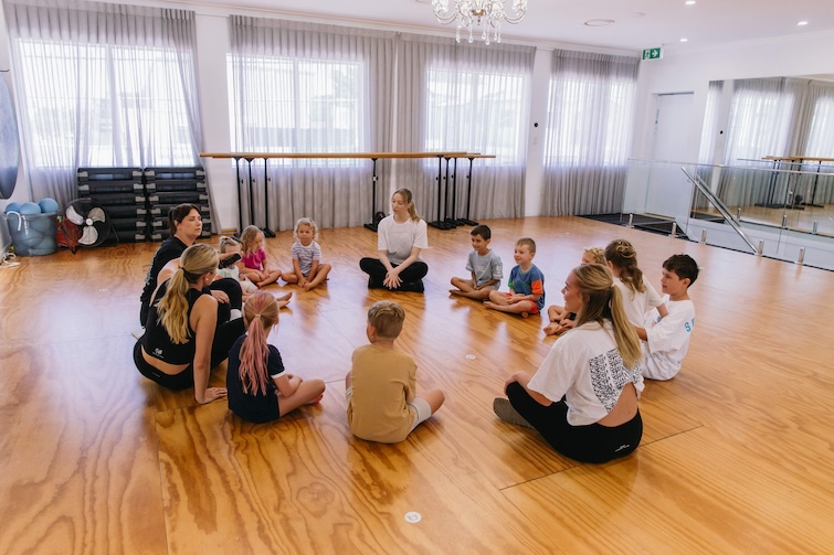 Children sitting on the floor iin a Dance Fiit kiids Class at Hawthorne. 