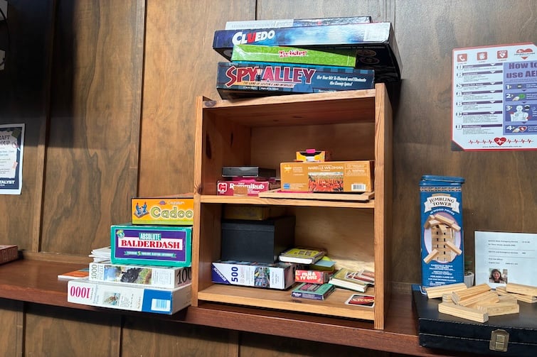 Shelves with board games at The Foundry Cafe in Brassall.