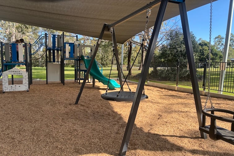 Fenced playground under shade sails at The Foundry Cafe in Brassall.