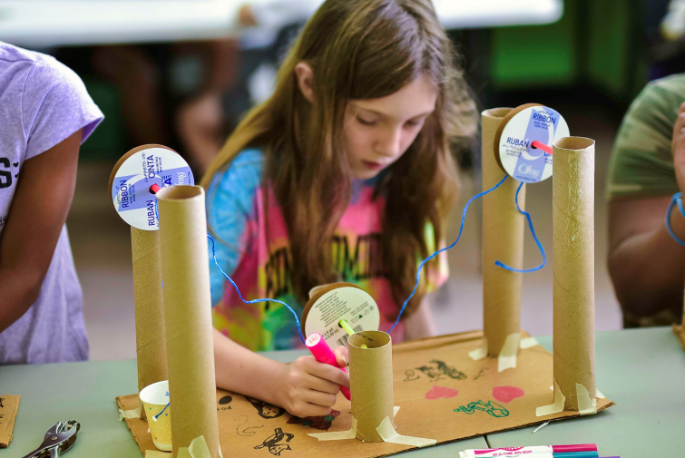 Engineering For Kids student building with cardboard tubes.