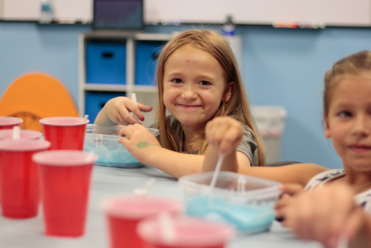 Engineering For Kids students stirring slime.
