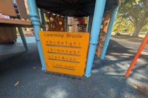 Learning braille sign at The Hills District All Abilities Park.