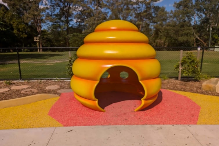 Yellow play beehive at The Hills District All Abilities Park.