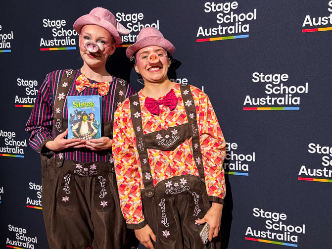 performers for Stage School Australia Shrek Jr holding the program
