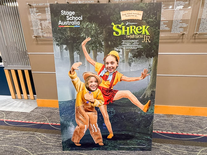 kids in character cut outs in the foyer at Shrek Jr
